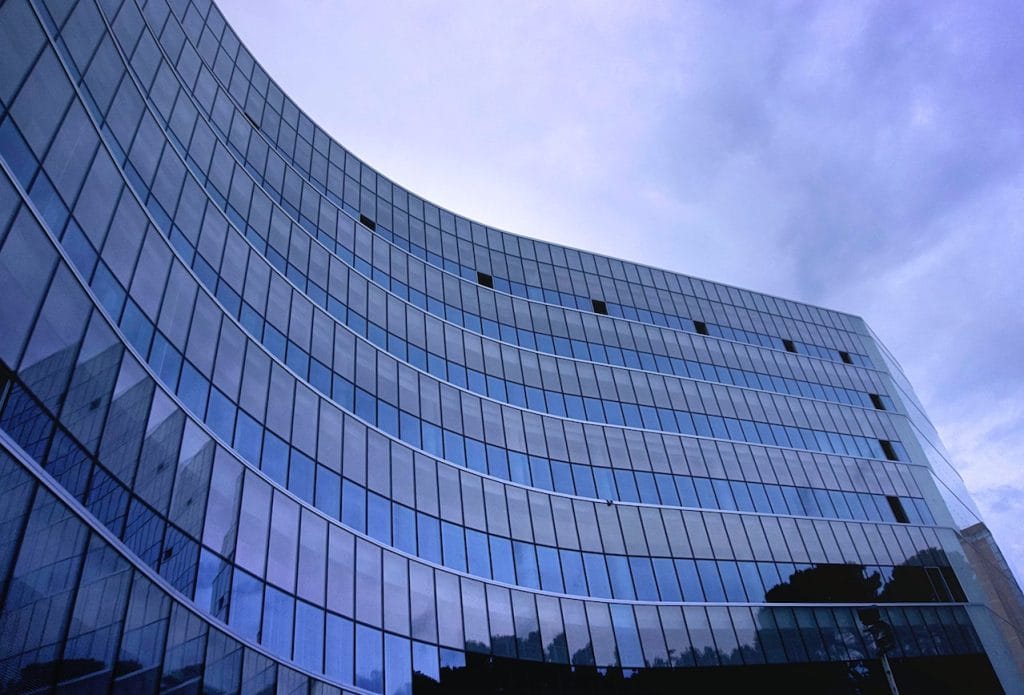 Modern building with curved glass façade reflecting sky