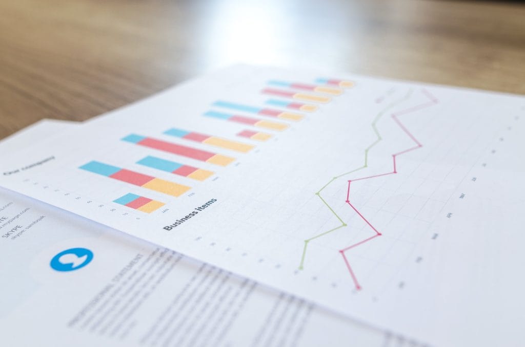Printed reports with charts on wooden table