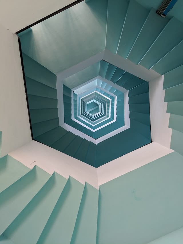 Looking up spiral staircase with geometric design