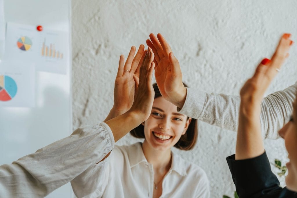 Team high-fiving in casual office