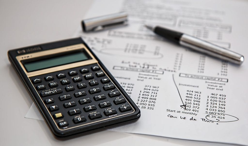 Calculator on financial documents with pen