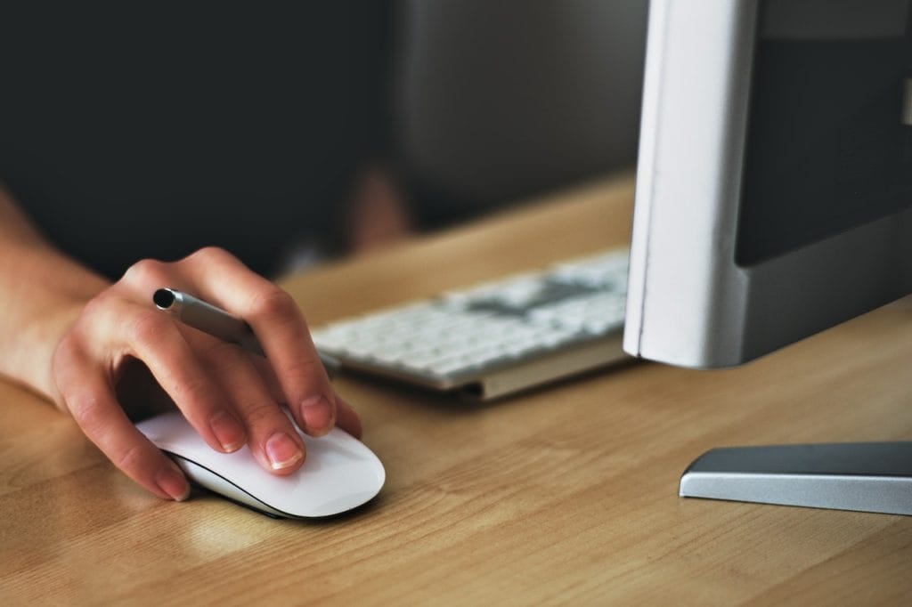 Hand using computer mouse at desk